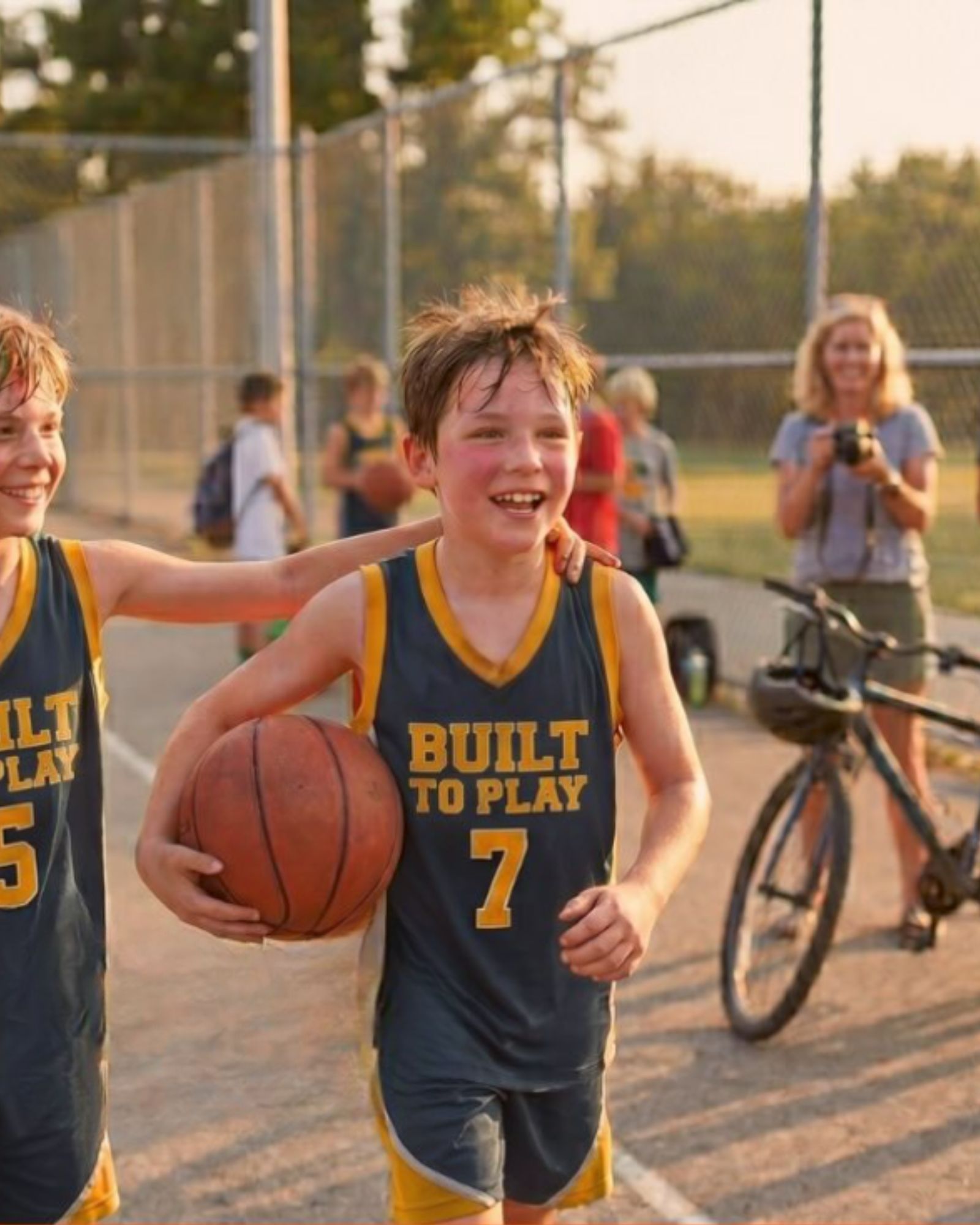 Young athlete in a Built to Play jersey holding a basketball